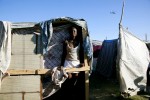 At Pont-Rouge refugee camp, 18 year old Haitian earthquake survivor Vaniola Paul stays at her tent where 4 family members live together, as a US military helicopter flies. She lost her brother in law due to the quake.