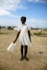 At Pont-Rouge refugee camp, 12 year old Haitian earthquake survivor Betina Paul stands with a water bottle container. She lost her uncle due to the quake.