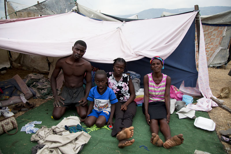 At Pont-Rouge refugee camp, Haitian earthquake IDP family, from the left, Wilvik Vakena, 29, Ifinder, 7, Metnise, 15, and Maciani, 46, stay inside their tent. Maciani lost her husband, daughter and brother due to the January 12th quake.