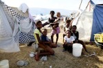 At Pont-Rouge refugee camp, Haitian earthquake survivors of the Petitfrere family stay next to their tent where 10 family members live together. 