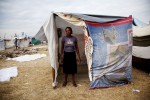 At Pont-Rouge refugee camp, Clautile Noel, 39 year old Haitian earthquake IDP, stands in front of her tent where she and her son live together. She lost her daughter due to the January 12th quake.