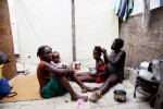 At Pont-Rouge refugee camp, Haitian earthquake IDP family, from the left, Roseline Etienne, 50, Wadline, 1 month, Regina, 8, and Leoger, 24, stay inside their tent. Leoger lost her father due to the January 12th quake.