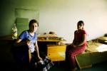 Newly arrived internally displaced people -- Galina Choncadze, 14 from Tskhinvali in South Ossetia, on the left, and Tamta Cugoshvili, 12 from Gori district--  stay at a refugee camp that used to be a former Soviet military compound. Tbilisi, Georgia, Aug. 16, 2008.