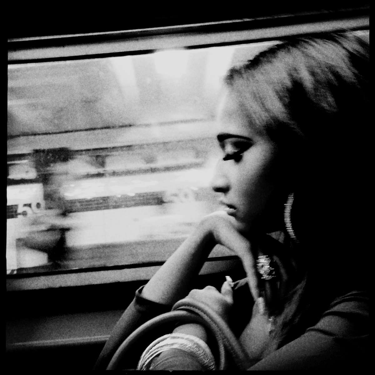 A woman in ennui at a New York subway train bound for Harlem and Bronx.