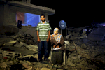 Assan Mohamed Najar, 30, and his 9 month pregnant and blind wife Tahreer Adnan Najar, 27, pose at their destroyed home in Khan Yunis due to Israeli artillery and airstrike during the summer’s 50-day war between Israel and Hamas. Despite their difficult and dangerous condition, they have to stay in the destroyed house, since there is no place else for them to move, or too expensive to do so. Khoza'a in Khan Yunis, Gaza. Oct/10/2014