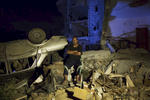 55 year old taxi driver Mohamed Abu Jama’a poses next to his  destroyed mercedes taxi and home in Khan Yunis due to Israeli airstrike and bulldozers during the summer’s 50-day war between Israel and Hamas. He has to still live at the site, since there is no place else for him to move, or too expensive for the rent after the war. Al-Zana'a in Khan Yunis, Gaza. Oct/08/2014