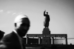 An Uighur man passes in front of a stature of Mao in Kashgar, Xinjiang, as the Chinese modernization projects or Chinesefication expand into the province. 