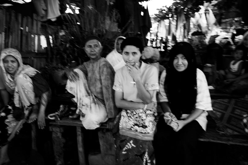 Muslims stay together late afternoon at a Muslim fisherman village of Narathiwat in South Thailand where the majority is Muslims and they are often in poverty compared to Thai Buddhists. Due to the strong Buddhism identity of Thailand, many southern Muslims feel themselves in limbo and a certain number of the people look for the independence or joining together with Malaysia. Unfortunately the bloody separate insurgency continues. April 10 2008, Narathiwat, Thailand.