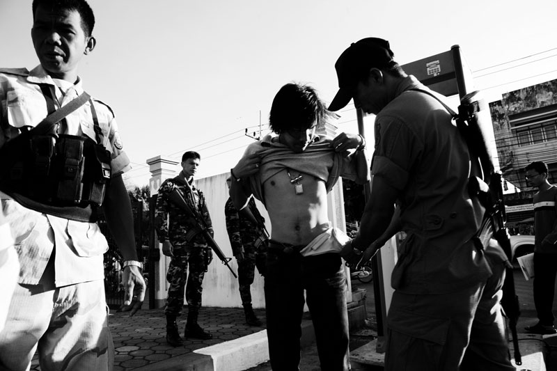 Police and soldiers inspect participants during the Army recruitment at a sport center in Yala in South Thailand where the majority is Muslims and Muslim separate insurgency continues. April 08 2008, Yala, Thailand.