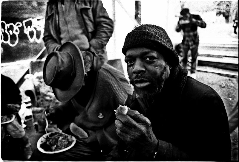 Homeless men take Christmas meal at the soup kitchen of an empty lot called La Plaza. December 25 1987.