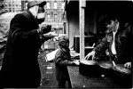 Homeless men, including a child, take Christmas meal at the soup kitchen of an empty lot called La Plaza. December 25 1987.