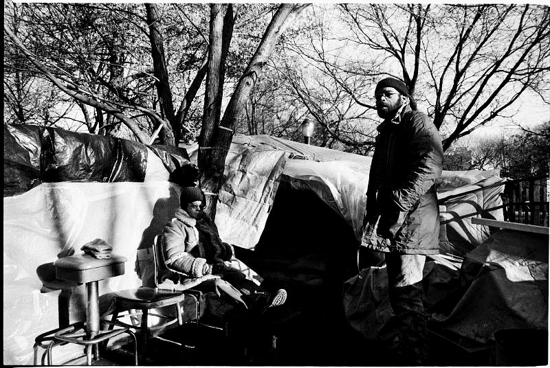 A homeless couple stay at their tent in Tompkins Sq Park due to no safe and proper place to go, while fearing the rumor of the coming forceful eviction from the park. New York, Dec 07, 1989.