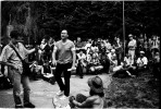 Art, a squatter and one of Tompkins Sq Activists, speaks out for how to fight to protect their human rights, while Paul, a reporter of WBAI, documents the speech, and homeless people, squatters, and supporters listen to him. New York, Very later afternoon in June 03(?), 1991.