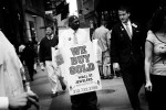 In Wall street, a man holds a placard of {quote} We Buy Gold{quote}, as gold pricehas increased due to the current financial crisis or economic melt-down.New York, Oct 13 2008.