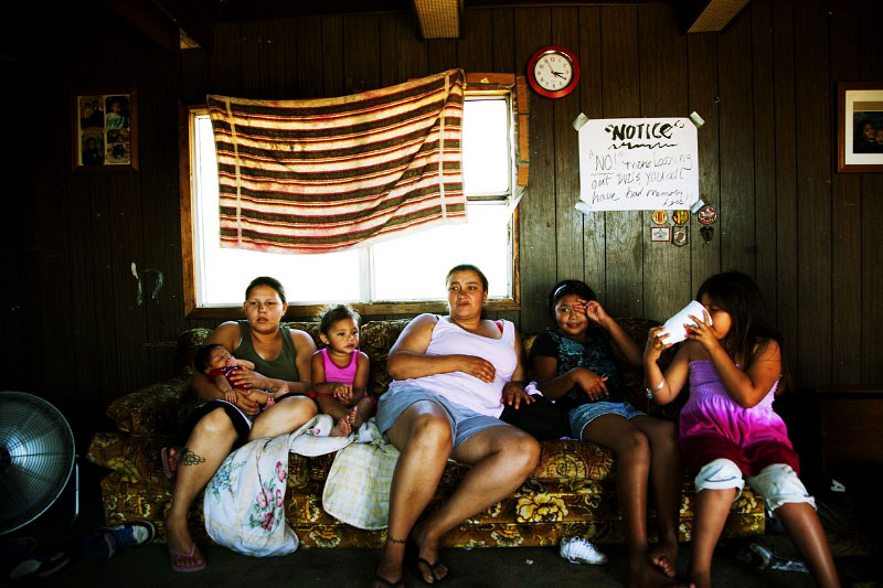 Dewey's Lakota family -- from the right, Mekayla, 7, Mycala, 10, Elizabeth, 31, her daughter Christina, 2, Andrea, 22, and her baby stay at their trailer-house where 13 people altogether live and it is very damageable if strong wind hits it. 