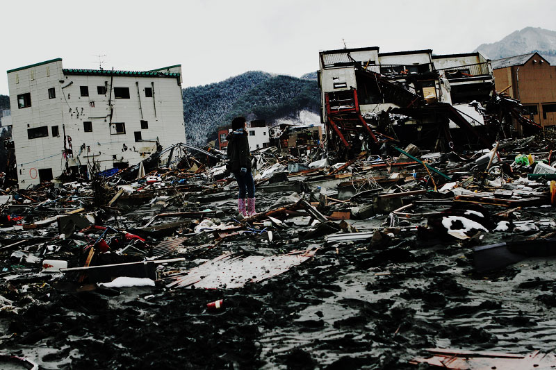 A young female survivor stuns looking at he destroyed scene of Otsuchi, Iwate, due to the unprecedented tsunami in Japan, created by the March 11th magnitude 9 earthquake. Like other towns of this photo essay, more than half of the Otsuchi populatoin have disappeared due to the monster tsunami.