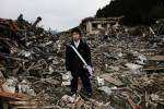 16 year old tsunami survivor Tsubasa Sudo stands at the debris near his destroyed house, as he comes back for the first time after the tsunami -- 3/11.