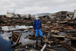 Tsunami survivor Yuji Takagi stands at the debris of his father's destroyed house, as he is searching for him, though probably the body. Kesennuma.
