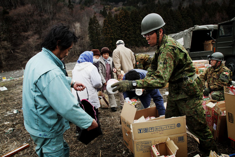 Japanese  Army distribute preserved packs of noodle to residents at a tsunami affected area in Otsuchi, as also suffer with the lack of food and water, but they can only get 5 packs of noodle a person per week, since the distribution is very scarce, like this image.