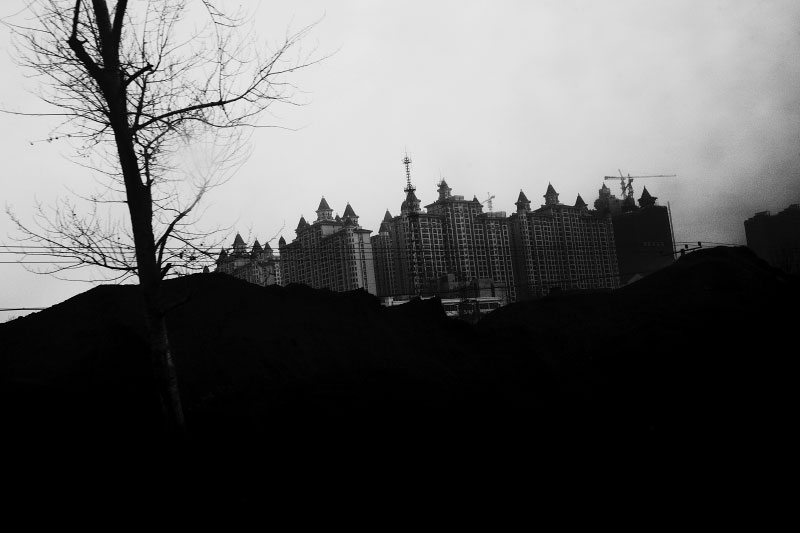 High-rise luxurious residential buildings are seen over coal slag piles at Harbin. Coal is still a primary source for power, heating and cooking fuel in China, despite the environmental health hazards.