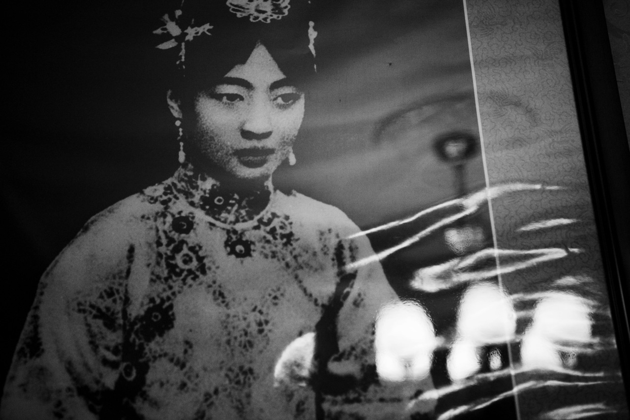 With the chandelier reflection, a photograph of Lady Gobulo (Empress Xiaokemin) remains at the former Imperial Palace of Manchukuo, or the Manchu State, where her husband, Manchukuo emperor Puyi, or China's last emperor of the Qing dynasty before the throne, stayed as Japanese puppet from 1932 to 1945. Changchun, Jilin province, China's North East.China's North East was once called Manchuria. The region was at a crossroads that was manipulated in history, including the occupation by Russia and Japan. And now the area is facing upheavals due to the globalization with China’s rapid economic growth itself, creating the gap between the rich and the poor and even more unemployment.