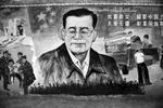 A propaganda mural with Chinese president Hu Jintao is displayed in the street in Tulufan, Xinjiang.