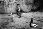 In a favela of Cidade Nova, woman and her baby refuge into a sidewalk from humid and hot weather. Feb 2008.