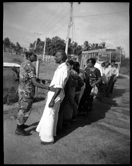 Tamils are forced to get off the bus and to be checked by at a government checkpoint of the war-torn town of Jaffna, one of the most critical places for LTTE and the Sri Lankan government -- the absolute majority of the town is Tamil but controlled by the government. In Jaffna, unemployment prevails and a large number of people have been escaping as refugees due to the long civil war and the current fresh fighting, as well as Tsunami. Jaffna, Sri Lanka, June 23, 2006.