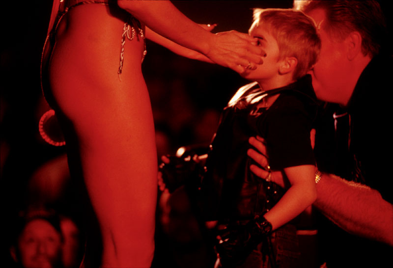A boy is lifted to the stage to meet Miss Easyrider at a bike show in Columbus, Ohio.