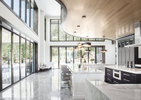 Interior marble kitchen countertops, floor, and glass sliding doors leading to backyard