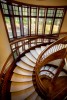 Interior high angle view of wooden spiral stairwell 