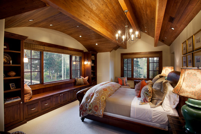 Interior guest bedroom with white carpet low wooden ceiling