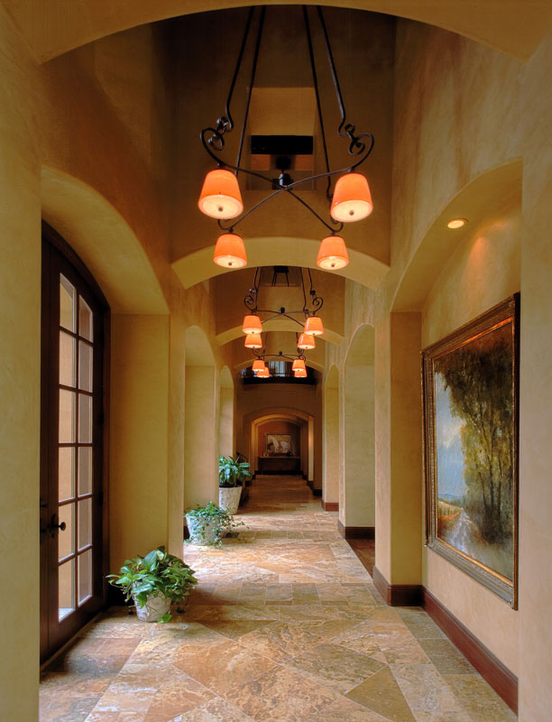 Interior hallway with stone tiled floor and art aligning walls