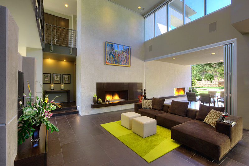 Interior family room, firepit, and sliding glass window leading to back pool area. 