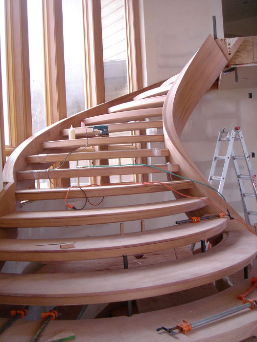 Interior low angle under construction wooden stairwell