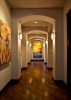 Interior, well lit hallway with framed art aligning the walls 