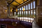 Interior upper level bar countertop with high glass curved windows 