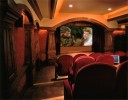 Interior home theatre with wooden framing and red velvet theatre seating