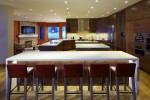 Interior kitchen with white stone countertops  and wooden cabnitrey