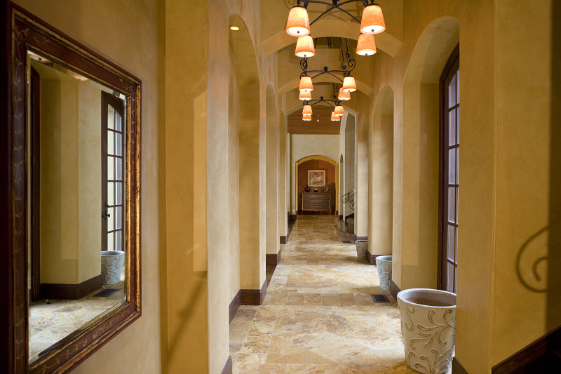 Interior hallway with tiled floor and mirrors aligning the walls 