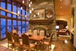 Interior family dining table and stone veneer fireplace with chandalier 