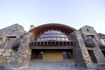 Exterior eye level view of backside outdoor deck and stone veneer structual columns 