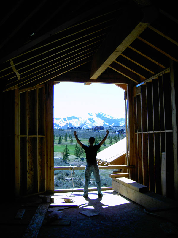 Interior image of window pane under construction with employee posing