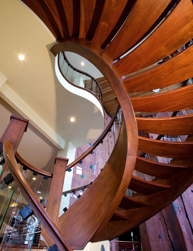 Interior bottom view of spiral wooden stairwell 