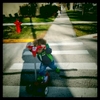 Luka scooting away as fast as he can after he swiped Rose's scooter on the way home. March 2016.