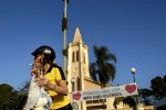 A member of the Moto Clube Robalos Rebeldes holds Our Lady of Rocio before a procession through the city. The procession stated at the  State Shrine of Our Lady of Rocio in Paranaguá, PR, Brazil.