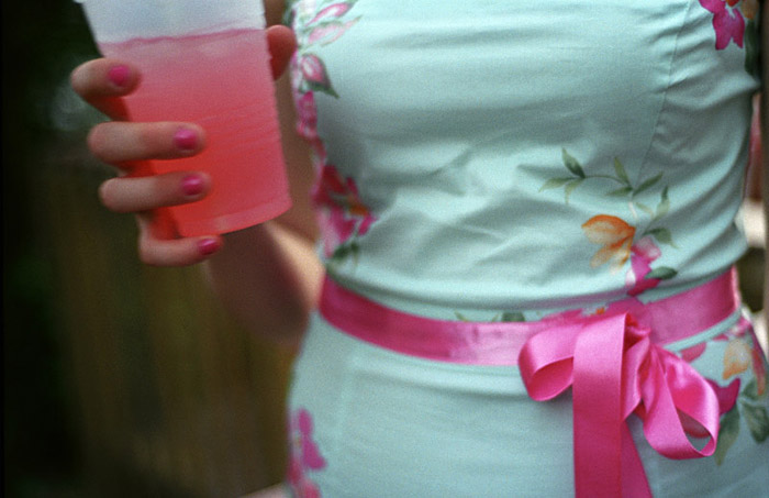 A sorority girl holds a drink at {quote}Date Party{quote} at the Theta Chi house. {quote}There's definitely a fraternity look. You can really tell at OU who's a fraternity guy or a sorority girl and who's artsy.{quote}