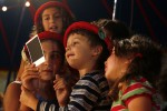 Children gather together to watch as their Polaroid with Cavalino develops. During intermission children are allowed to enter the ring and get their picture taken, for a fee, with Tosca and Cavalino. This is the most popular souvenir at the show.