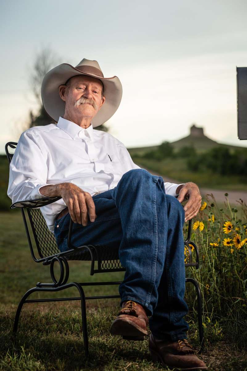 Ray Stokes sits for a portrait with his beloved Council Butte in the distance two months prior to his passing.