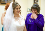 Alissa's mom Sherrie reacts as the bride has her dress buttoned by Laura, the Maid of Honor. Wedding pictures by Tiffany & Steve of Warmowski Photography. 